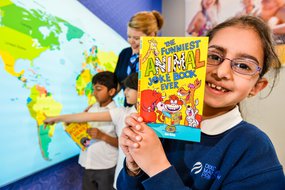 Primary child with non-fiction book