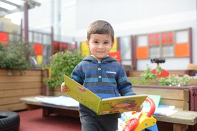 Boy_in_blue_reading.jpg