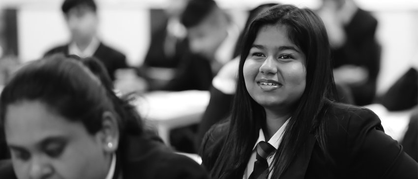 Busy classroom secondary girl greyscale National Literacy Trust