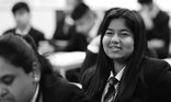 Busy classroom secondary girl greyscale National Literacy Trust