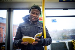 Adult reading on train