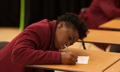 Secondary school boy writing - small