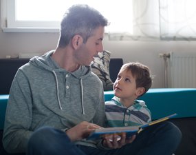 Dad and son sharing a book.jpg