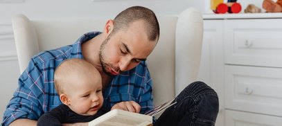 Dad reads with his baby making sounds