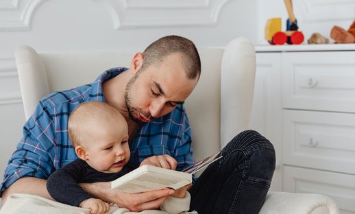 Dad reads with his baby making sounds