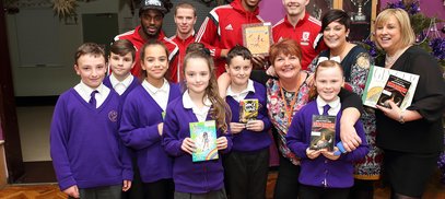 MFC footballers give out books