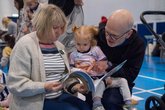 Grandparents reading to Grandchild