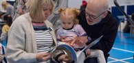 Grandparents reading to Grandchild