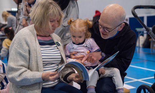 Grandparents reading to Grandchild
