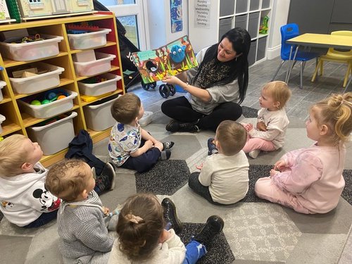 Karly reading to some of the children in her childcare setting