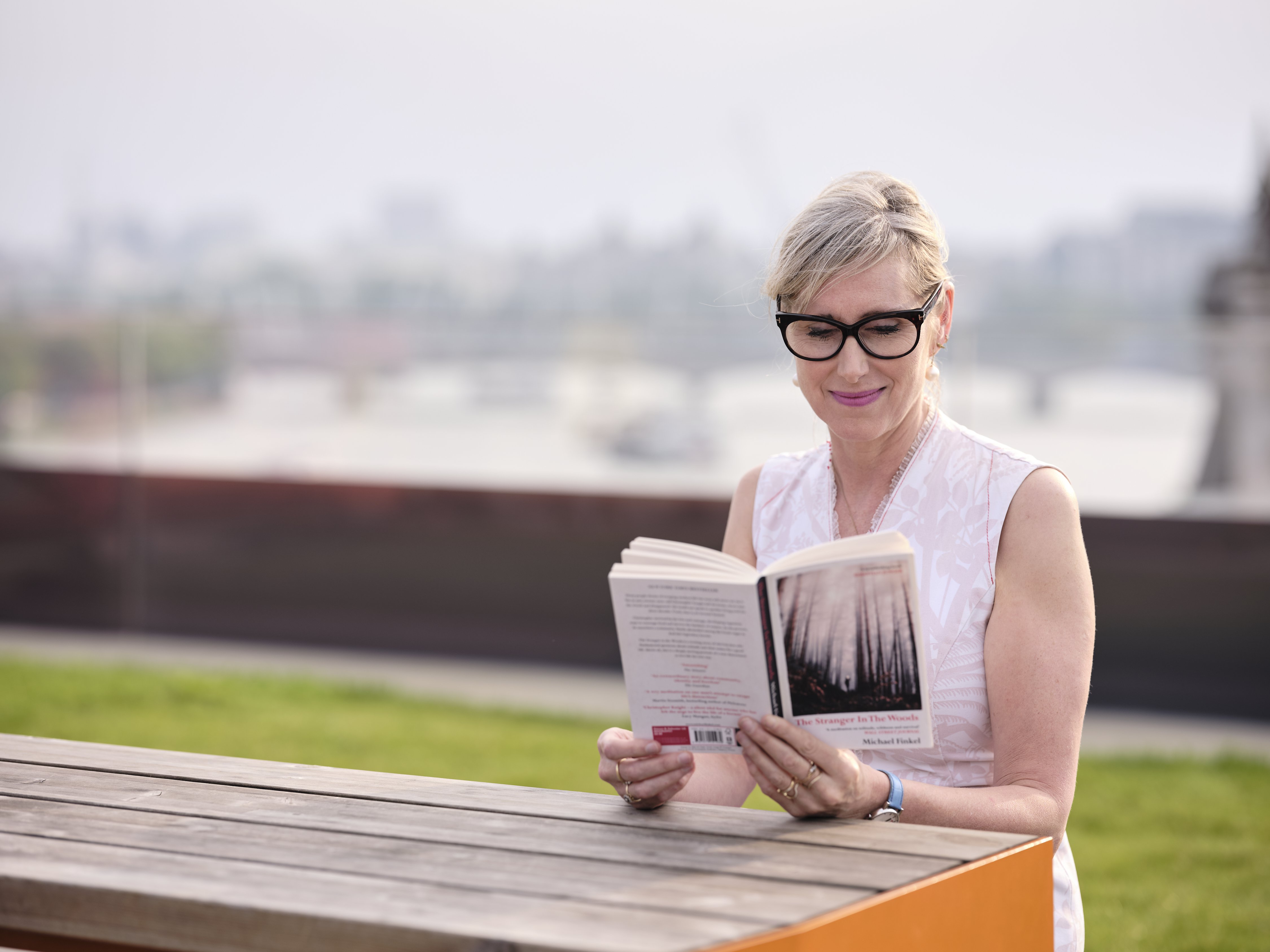 Lauren Child MBE, Children's Laureate and bestselling author, takes a moment to enjoy a book outdoors.jpg