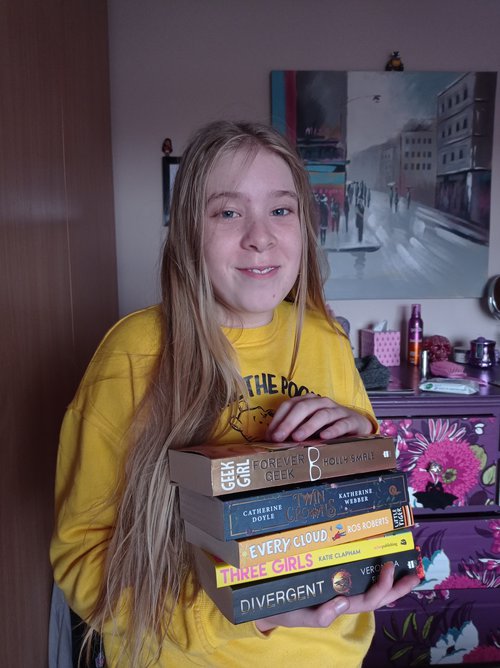 Lucinda Farrell, holding her prize of books and a voucher