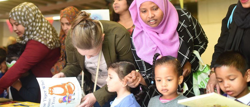 Mother_and_kids_looking_at_books.jpg