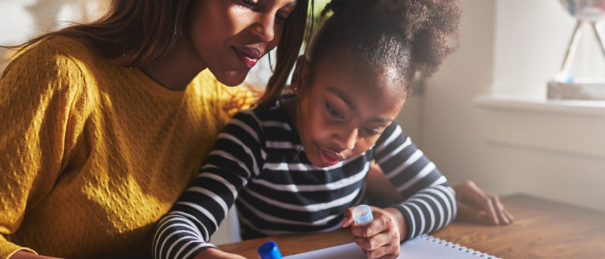 Mum and daughter writing