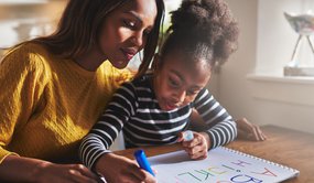 Mum and daughter writing