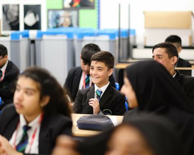 Secondary school classroom - pupils laughing while sat at desks