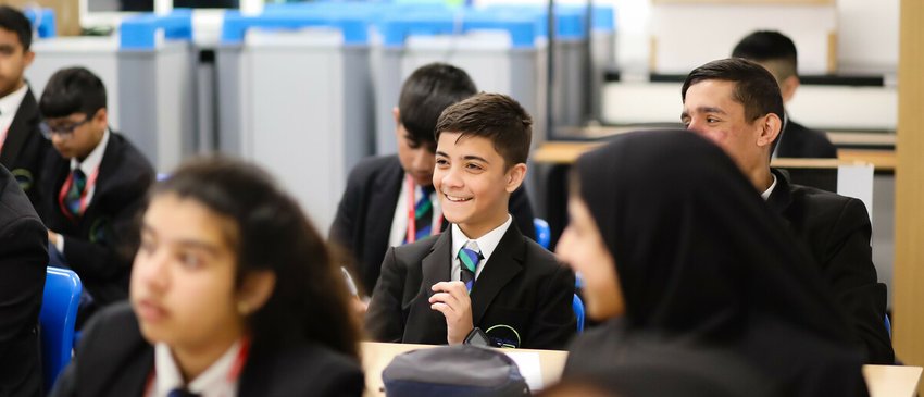 Secondary school classroom - pupils laughing while sat at desks