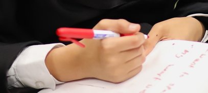 Close up of a student writing during a National Literacy Trust poetry workshop