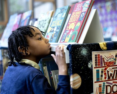 Child looking at books in a library