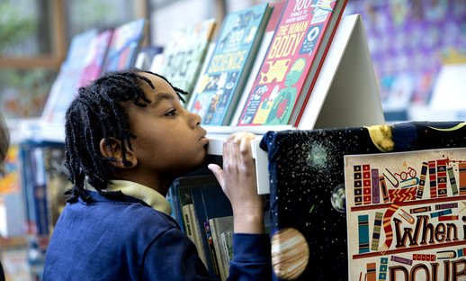 Child looking at books in a library
