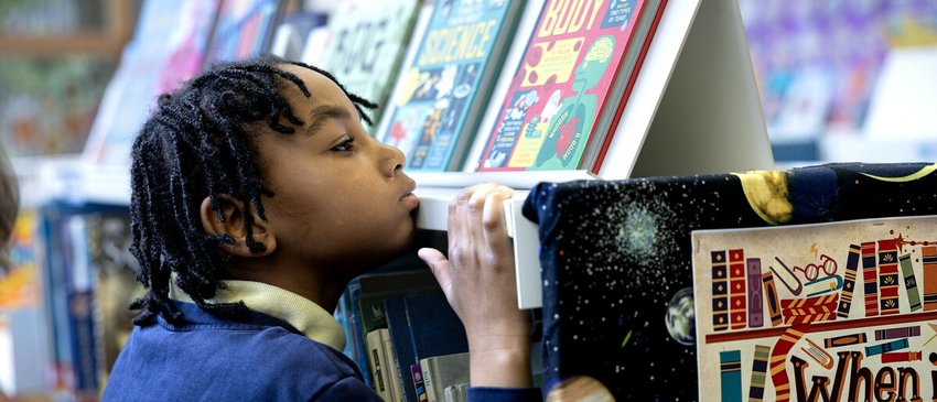 Child looking at books in a library