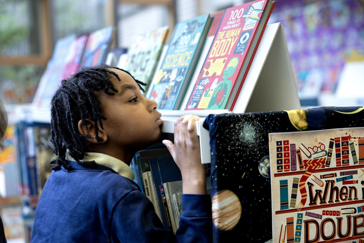 Child looking at books in a library