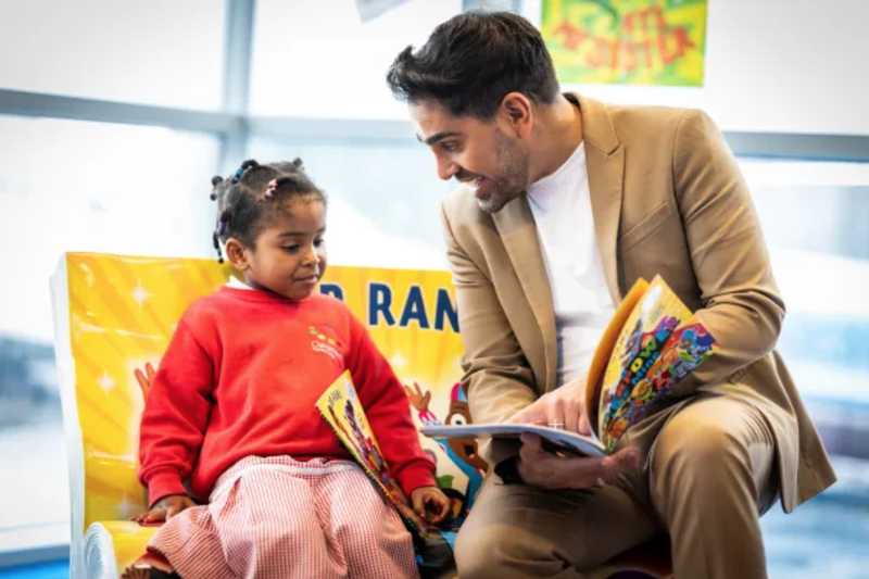 Dr Ranj reading A Superpower Like Mine to a pupil