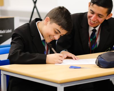 Secondary school young people boys classroom writing_National Literacy Trust