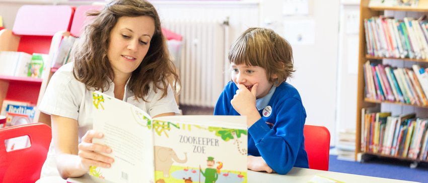 Teacher reading with child.jpg