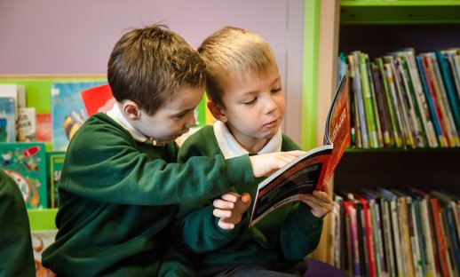 Primary boys share a book