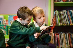 Primary boys share a book