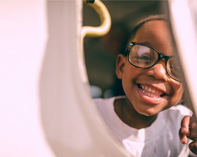 Young child girl big smile close up face early years_National Literacy Trust