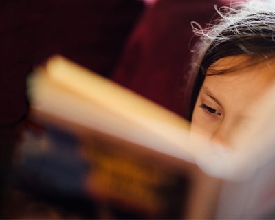 Young child reading_ book close up_National Literacy Trust