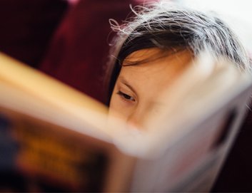 Young child reading_ book close up_National Literacy Trust