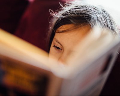 Young child reading_ book close up_National Literacy Trust