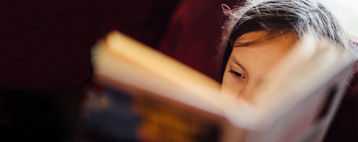 Young child reading_ book close up_National Literacy Trust