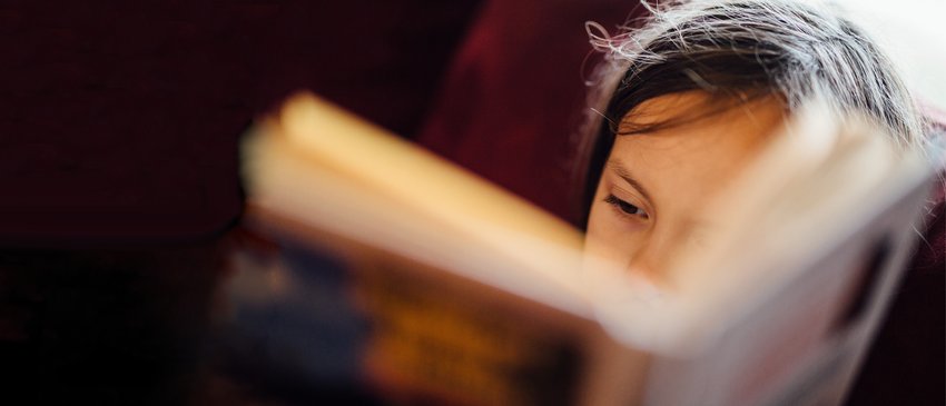 Young child reading_ book close up_National Literacy Trust