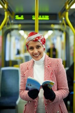 author-headshot-on-tram-distant