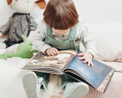 A toddler looks at a picture book