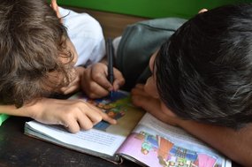 Children reading as part of their transition day activities