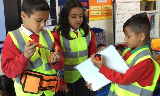 Three 6–7-year-olds from an East London school exploring the world of work by dressing up as engineers.