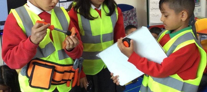 Three 6–7-year-olds from an East London school exploring the world of work by dressing up as engineers.