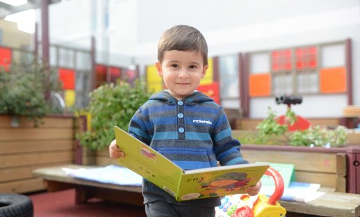 Early years boy with book