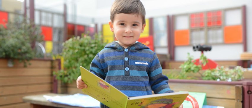 Early years boy with book