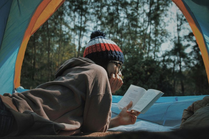 Person reading a book for pleasure