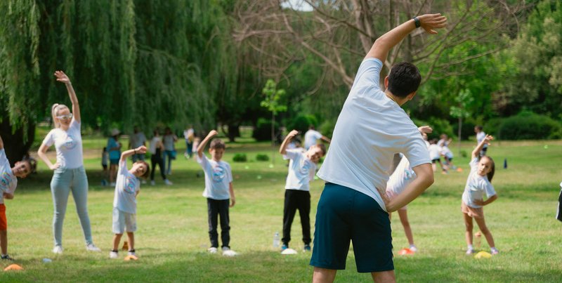 Group of children doing fitness activity outdoors