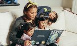 Mum reading with three children