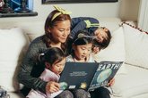 Mum reading with three children