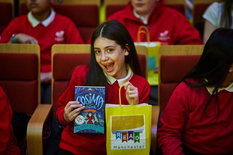Girl with book empathy day Mcr